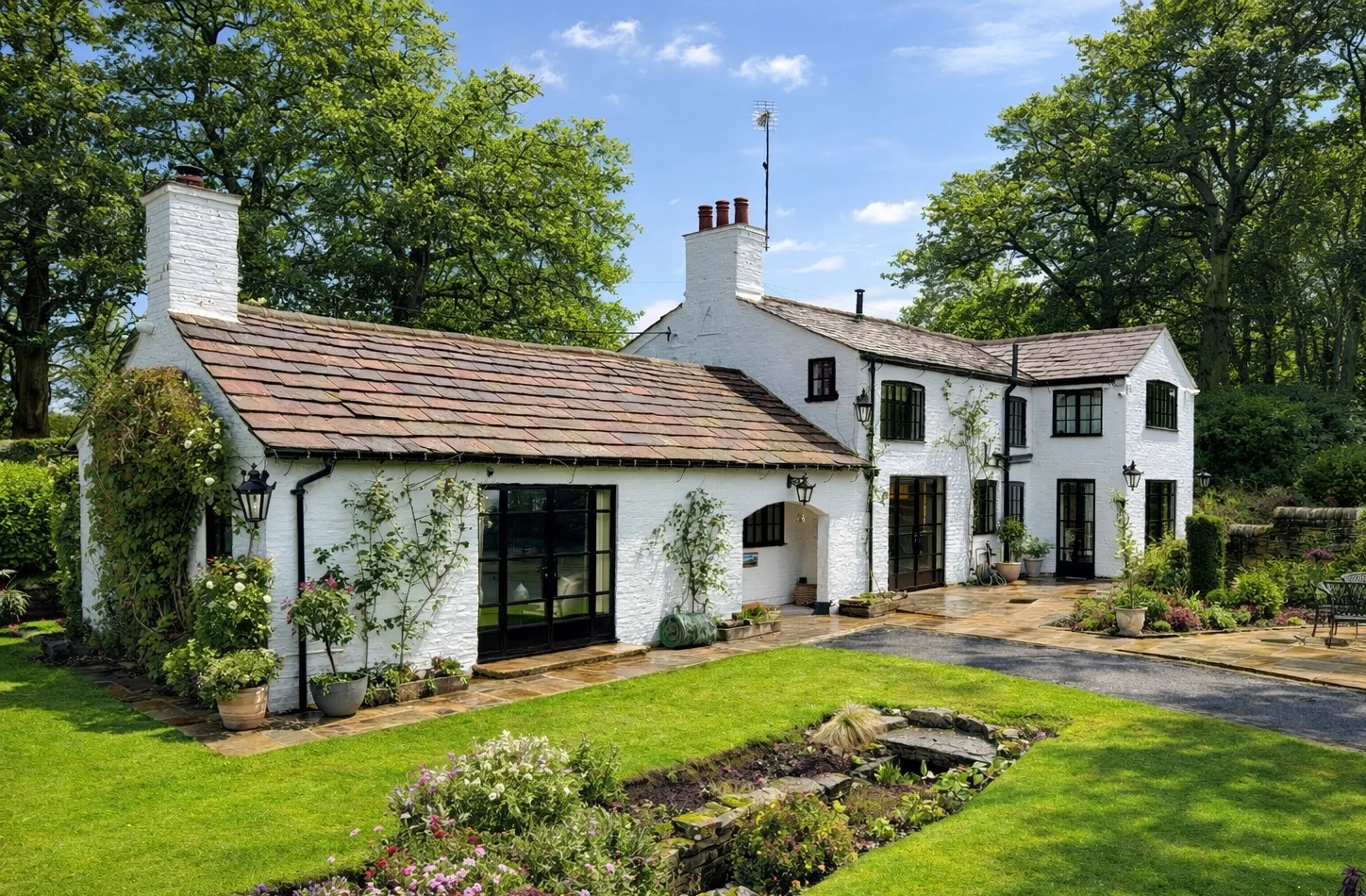 white country house with lawn featuring heritage french doors