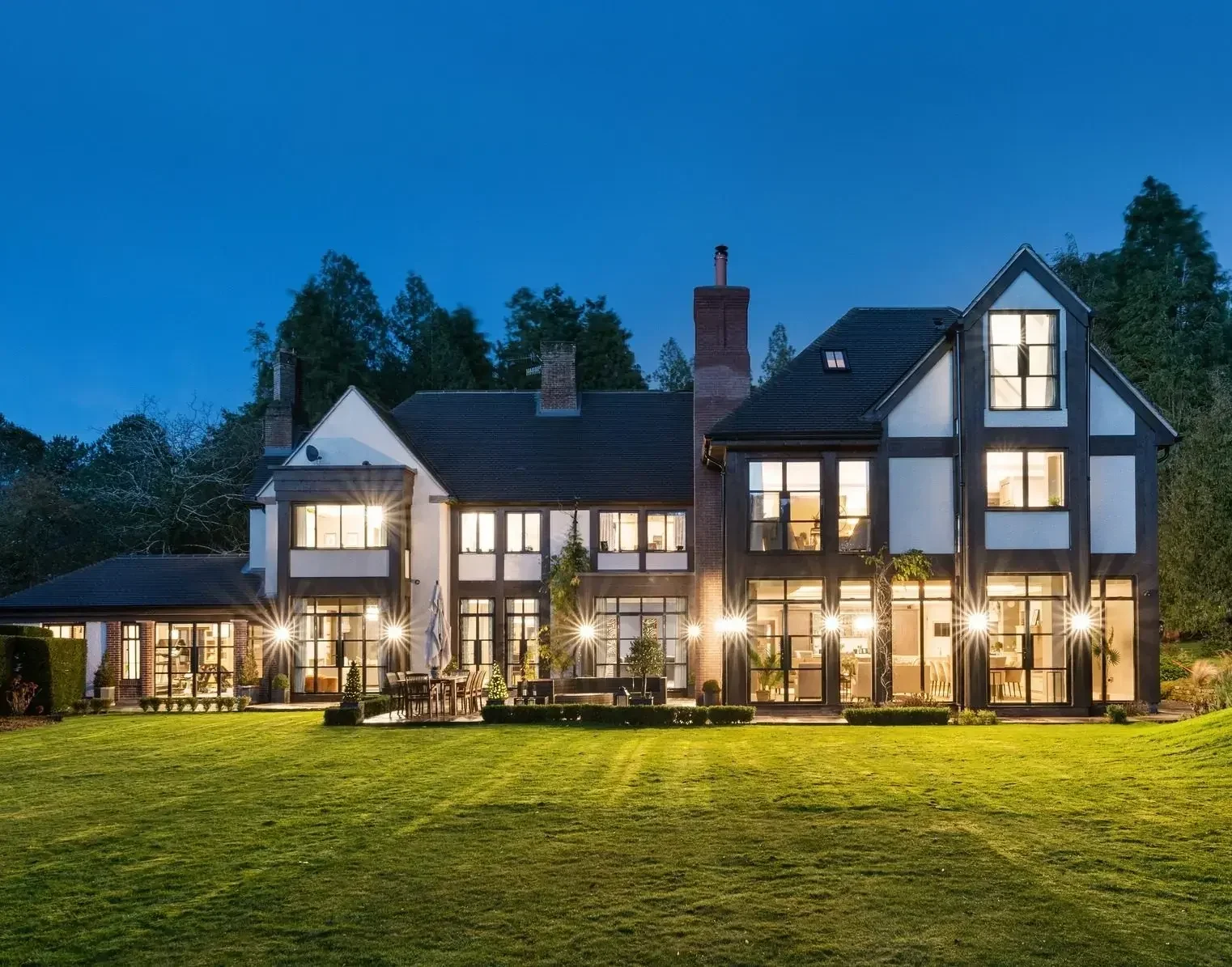 Batt House featuring Alitherm Heritage aluminium windows and doors, photographed at dusk.