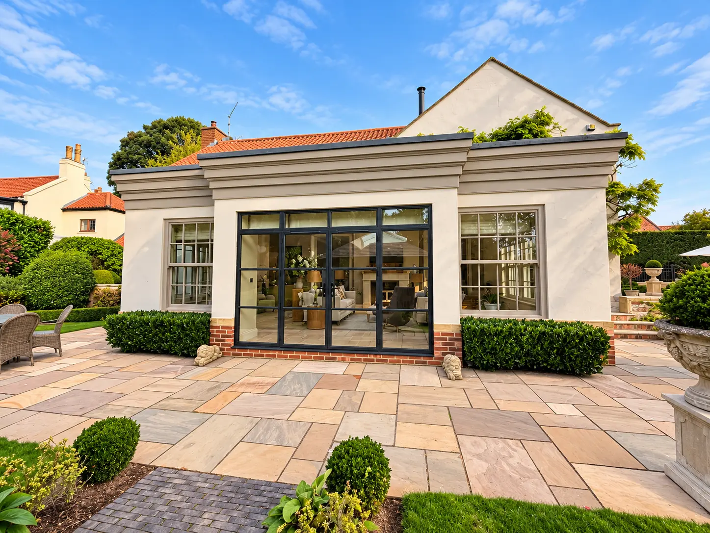 Black aluminium Georgian-style doors opening onto a garden patio